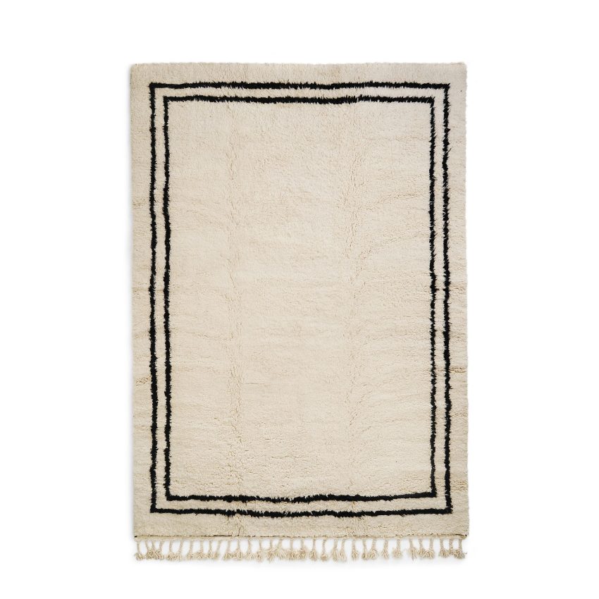 Large rug in wool white beige with black frame